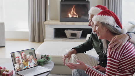 Glücklicher-Kaukasischer-Vater-Mit-Söhnen-Und-Eltern,-Die-Einen-Weihnachtlichen-Laptop-Videoanruf-In-Zeitlupe-Führen