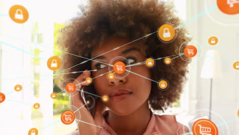 Animation-of-network-of-connected-icons-in-circles-over-african-american-woman-using-smartphone