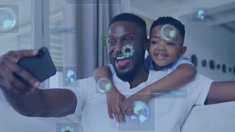 Animation-of-data-over-happy-african-american-father-and-son-taking-selfie-at-home