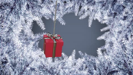 Animation-of-hanging-gift-box-swinging-over-snow-covered-pine-leaves-against-gray-background