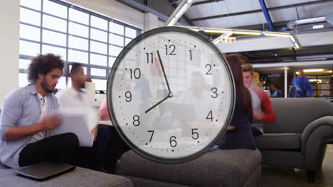 Animation-of-clock-ticking-over-diverse-business-people-in-office