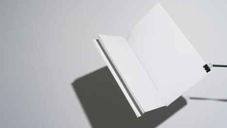 Video-of-hanging-book-with-white-blank-pages-and-copy-space-on-white-background
