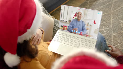 Happy-diverse-couple-and-senior-father-having-christmas-laptop-video-call,-slow-motion