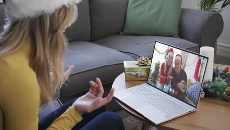Happy-caucasian-couple-and-female-friend-having-christmas-laptop-video-call,-slow-motion