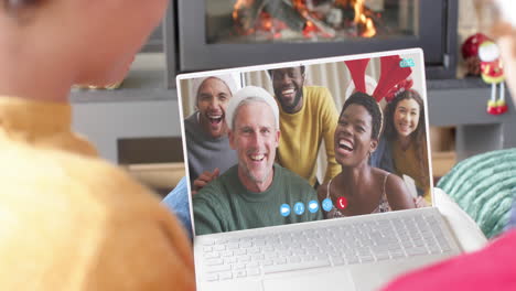 Happy-diverse-couple-and-friends-having-christmas-laptop-video-call,-slow-motion