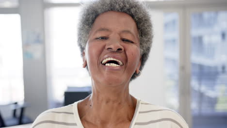 Portrait-of-happy-african-american-senior-woman-in-hospital,-slow-motion