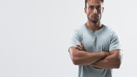 Young-biracial-athlete-man-stands-confidently,-with-copy-space-on-a-white-background