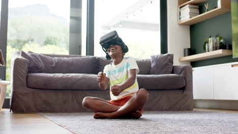 Happy-african-american-boy-in-vr-headsets-playing-with-virtual-interface,-copy-space,-slow-motion
