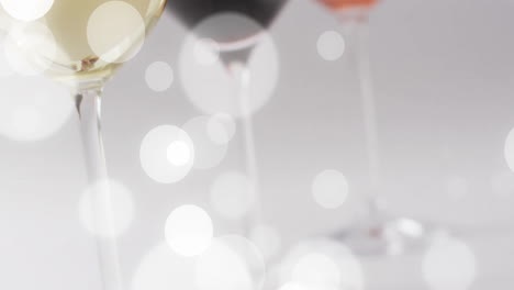 Composite-of-glasses-of-white,-rose-and-red-wine-over-white-background