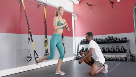 Fit-young-Caucasian-woman-trains-with-an-African-American-man-at-the-gym