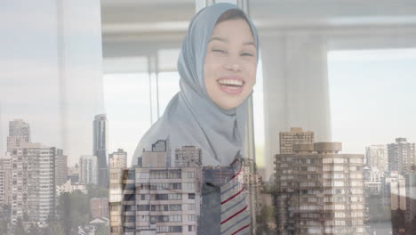 Animation-of-cityscape-cover-biracial-woman-in-hijab-smiling