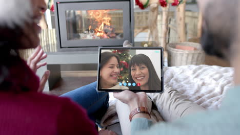 Happy-diverse-couple-and-mother-with-daughter-having-christmas-tablet-video-call,-slow-motion