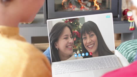 Diverse-mother,-daughter-and-male-friends-having-christmas-laptop-video-call,-slow-motion
