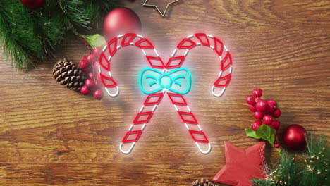 Animation-of-candy-canes-with-ribbon-over-christmas-tree