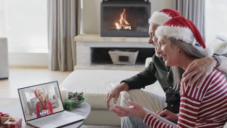 Happy-caucasian-couple-and-adult-daughter-having-christmas-laptop-video-call,-slow-motion