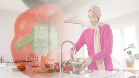 Mujer-Birracial-Con-Hijab-Lavando-Verduras-En-La-Cocina,-Cocinando-Sobre-Pimiento-Rojo