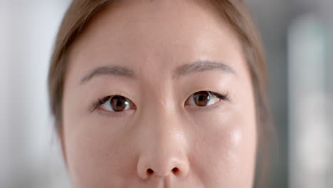 Close-up-of-a-young-Asian-woman's-face,-with-copy-space