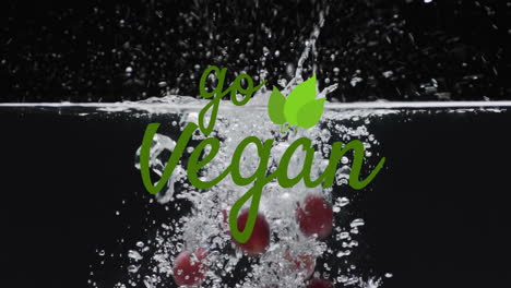 Animation-of-go-vegan-text-over-fruit-falling-in-water-background