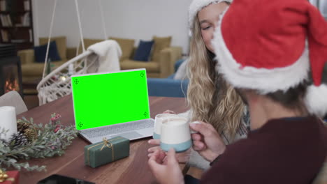Happy-caucasian-couple-having-christmas-laptop-video-call-with-green-screen,-slow-motion