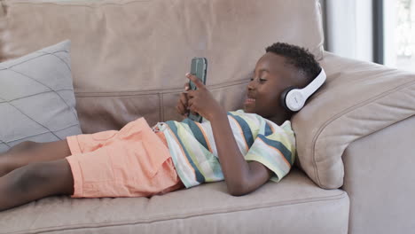 African-American-boy-enjoys-music-at-home