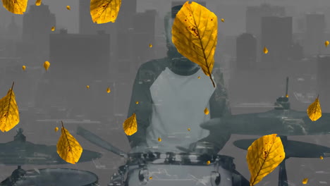 Animation-of-yellow-leaves-falling-over-caucasian-man-playing-drums-and-cityscape-on-grey-background