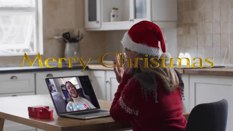 Animation-of-merry-christmas-text-over-caucasian-woman-on-laptop-screen