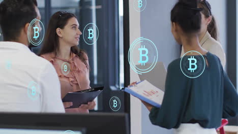 Animation-of-bitcoin-symbols-over-diverse-colleagues-having-meeting-in-office