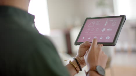 Biracial-Mann-Verwendet-Tablet-Mit-Smart-Home-Auf-Dem-Bildschirm-Zu-Hause,-Zeitlupe