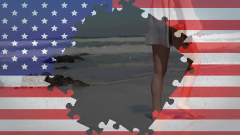Animation-Der-Flagge-Der-USA-Mit-Puzzleteilen-über-Einer-Kaukasischen-Frau,-Die-Am-Strand-Spazieren-Geht