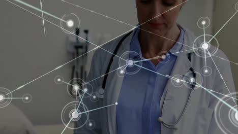 Animation-of-network-of-connections-over-caucasian-female-doctor-using-tablet