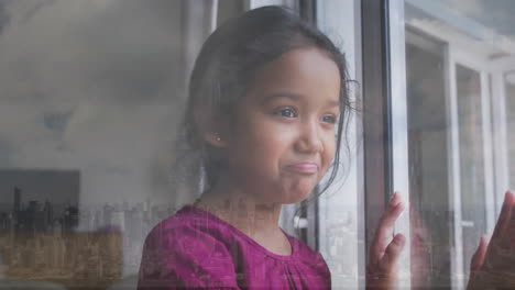 Animation-of-biracial-girl-looking-through-window-over-cityscape
