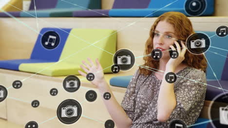 Animation-of-network-of-connected-icons-in-circles-over-happy-caucasian-woman-using-smartphone