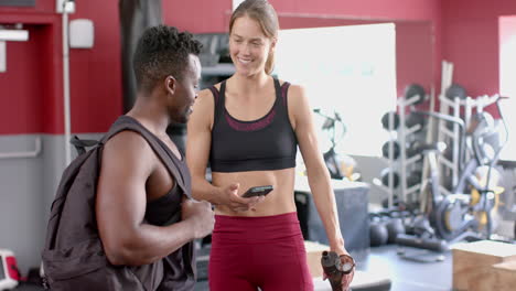 Fit-African-American-man-and-young-Caucasian-woman-at-the-gym