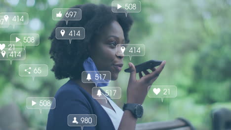 Animation-of-social-media-notifications-over-happy-african-american-woman-talking-on-smartphone