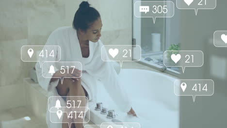 Animation-of-social-media-notifications-over-biracial-woman-in-robe-running-bath