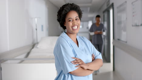 Confident-African-American-nurse-stands-in-a-hospital-corridor