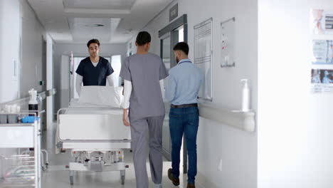 Healthcare-professionals-transport-a-patient-in-a-hospital-corridor