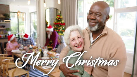 Animation-of-merry-christmas-text-over-happy-diverse-senior-friends-celebrating-christmas-at-home
