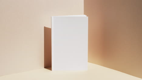 Video-of-book-with-white-blank-pages-and-copy-space-on-yellow-background