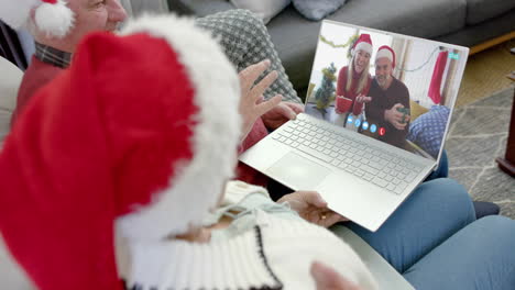 Two-happy-caucasian-couples-having-christmas-laptop-video-call,-slow-motion