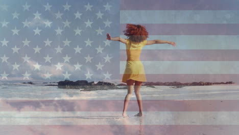 Animation-Der-Amerikanischen-Flagge-Und-Wolken-über-Einer-Afroamerikanischen-Frau,-Die-Am-Sonnigen-Strand-Tanzt