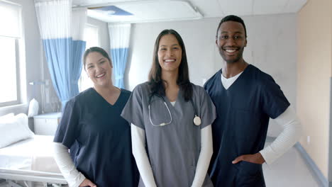 Portrait-of-happy-diverse-male-and-female-doctors-smiling-in-hospital-ward,-slow-motion