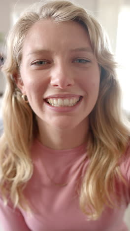 Vertical-video-of-portrait-of-caucasian-woman-talking-and-having-video-call-at-home,-slow-motion