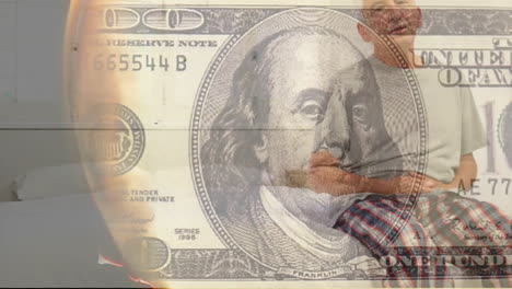 Animation-of-burning-dollar-banknote-over-senior-caucasian-man