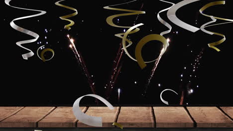 Animation-of-party-streamers-and-fireworks-on-black-background