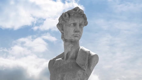 Animation-of-gray-sculpture-of-man-over-blue-sky-and-clouds