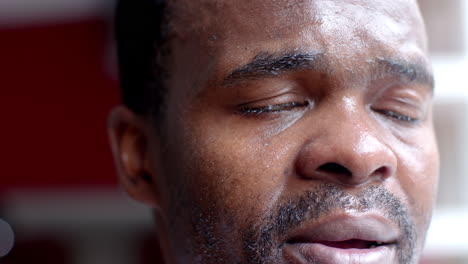 Close-up-of-an-African-American-man's-face,-showing-sweat-and-emotion