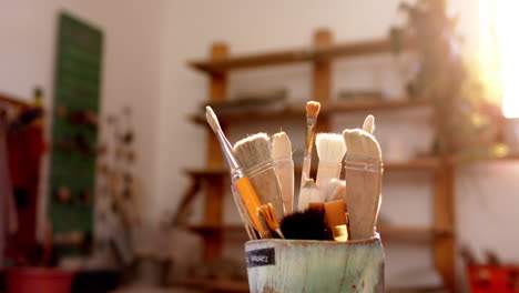 Box-with-pottery-brushes-on-desk-in-pottery-studio