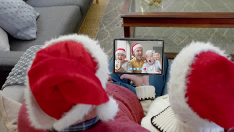 Happy-caucasian-couple-and-father-with-sons-having-christmas-tablet-video-call,-slow-motion