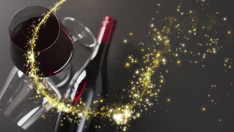 Composite-of-shooting-star-over-glass-and-bottle-of-red-wine-over-black-background